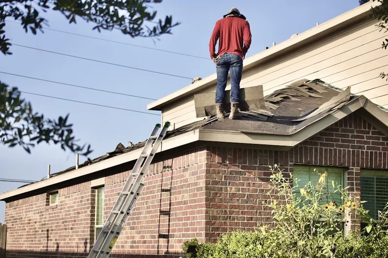 Professional roofer working on a residential roof in Edgewater